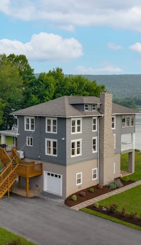 Aerial view of riverfront home on the Susquehanna with mountain backdrop